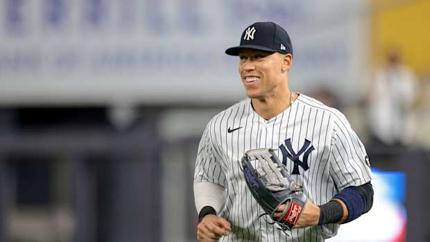 Aaron Judge smiling while running on defense